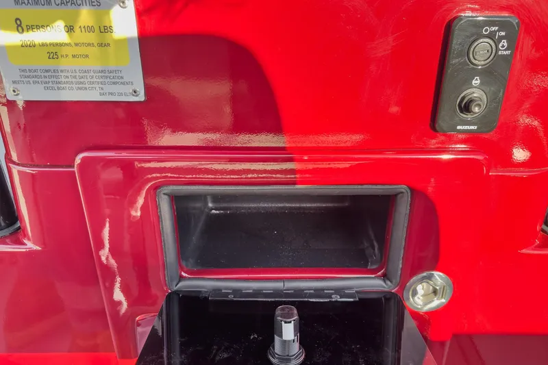 Slide: The Image of Red Excel Bay Pro Elite 220 boat dashboard with capacity label and control panel. - 25