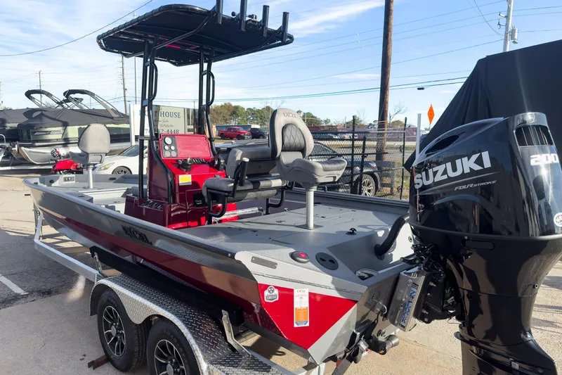 Slide: The Image of 2026 Excel Bay Pro Elite 220 boat with Suzuki 200 engine, parked on a trailer. - 4