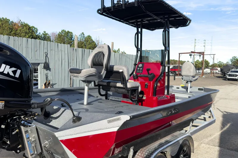 Slide: The Image of 2026 Excel Bay Pro Elite 220 boat with Suzuki engine, red and gray design, on trailer. - 5