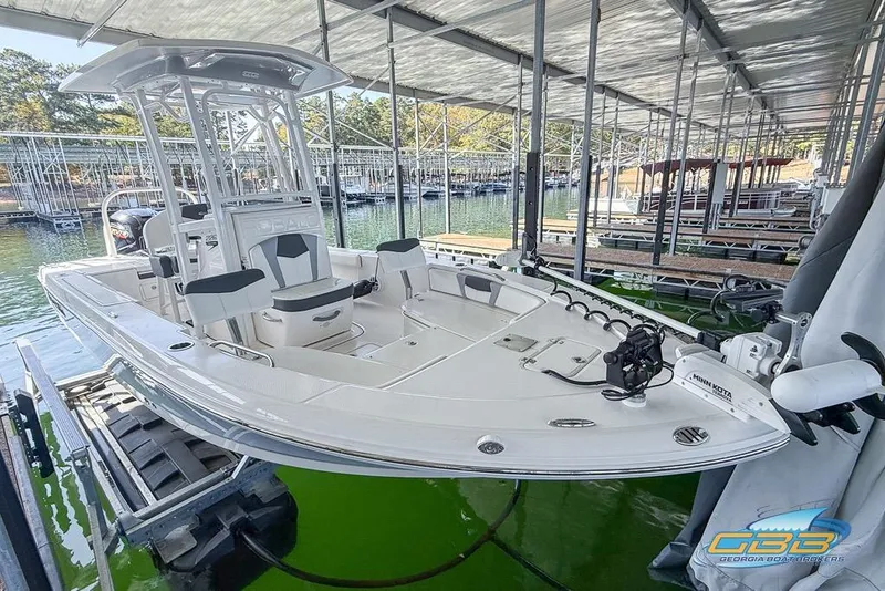 Slide: The Image of 2023 Robalo 226 Cayman boat docked in a marina, featuring sleek design and modern equipment. - 18