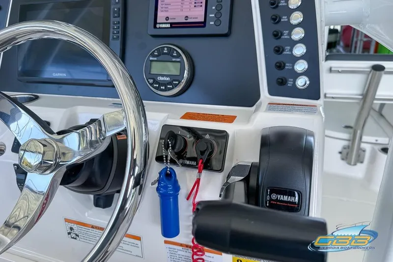 Slide: The Image of 2023 Robalo 226 Cayman boat dashboard with steering wheel and Yamaha controls. - 21