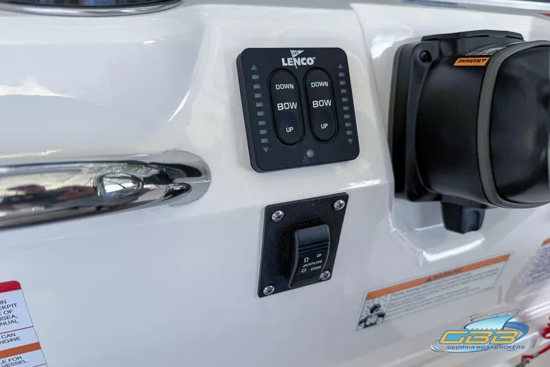 Slide: The Image of 2023 Robalo 226 Cayman boat control panel with Lenco trim tab switches. - 22