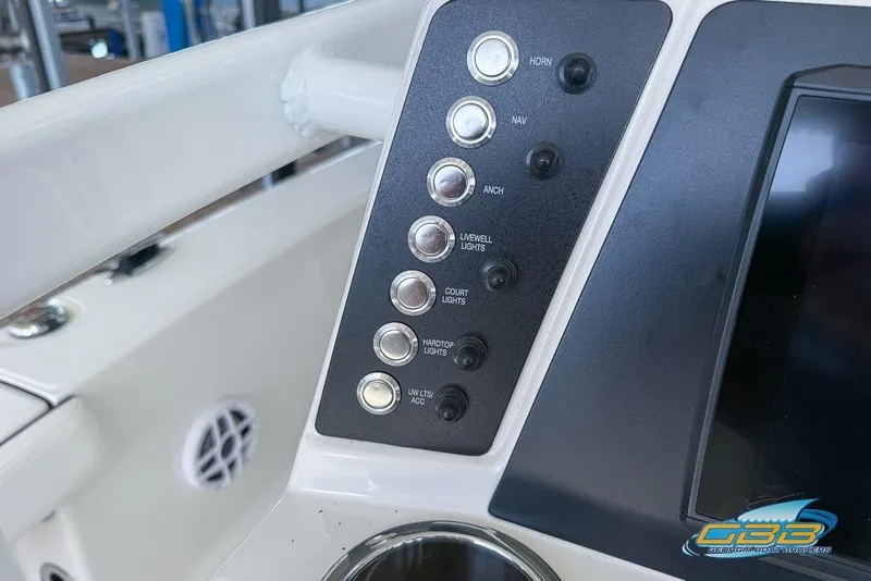 Slide: The Image of Control panel of 2023 Robalo 226 Cayman boat with various switches and buttons. - 23