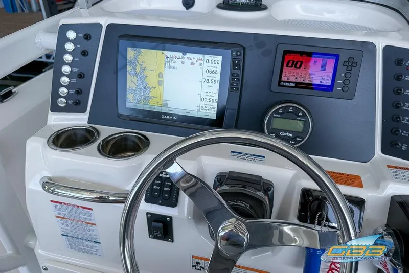 Slide: The Image of 2023 Robalo 226 Cayman boat dashboard with Garmin navigation and Yamaha display. - 24