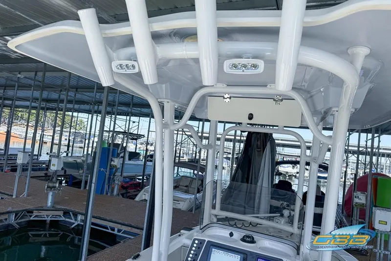 Slide: The Image of 2023 Robalo 226 Cayman boat interior with advanced navigation equipment at a marina. - 26
