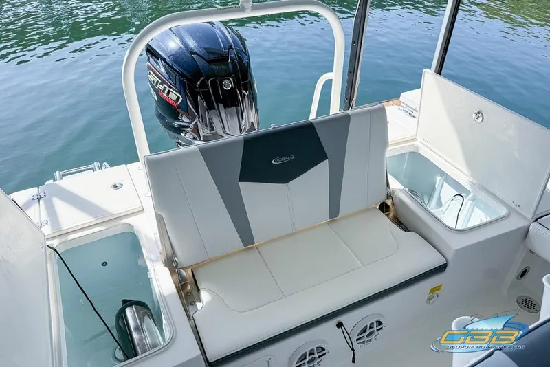 Slide: The Image of 2023 Robalo 226 Cayman boat interior with seating and Yamaha outboard motor. - 30