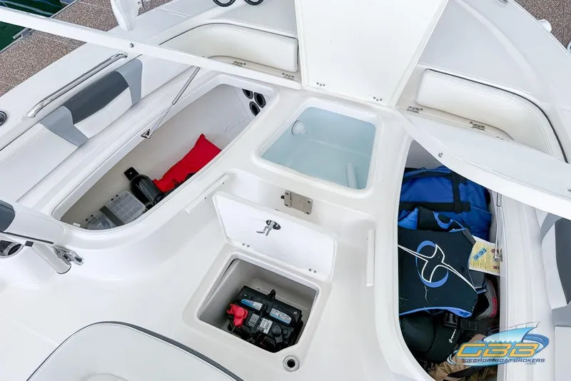 Slide: The Image of 2023 Robalo 226 Cayman boat interior storage compartments with gear and equipment. - 32