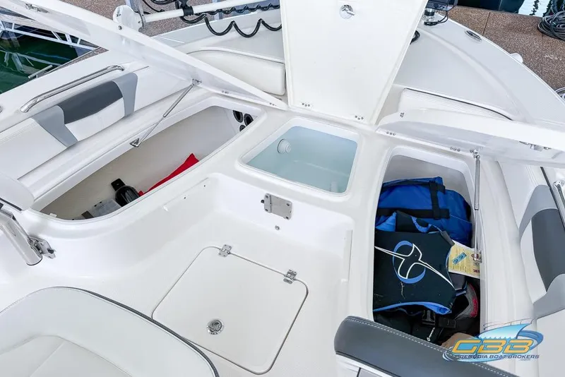 Slide: The Image of 2023 Robalo 226 Cayman boat storage compartments with gear and equipment. - 33
