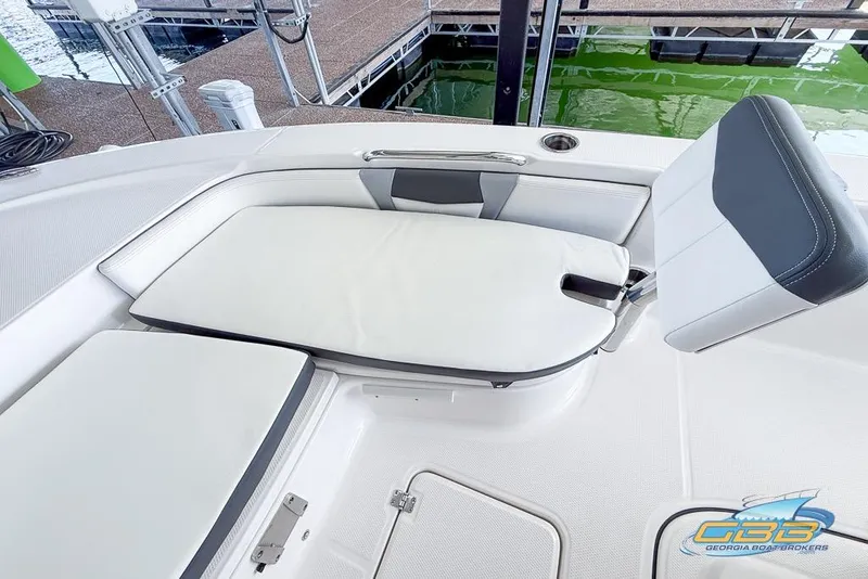Slide: The Image of 2023 Robalo 226 Cayman boat interior with cushioned seating and storage compartments. - 34