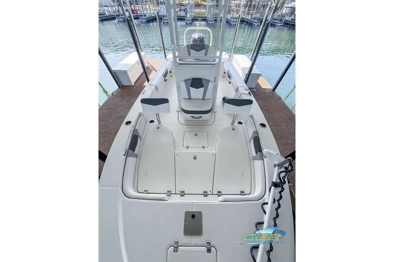Slide: The Image of 2023 Robalo 226 Cayman boat interior with seating and storage, docked at marina. - 37