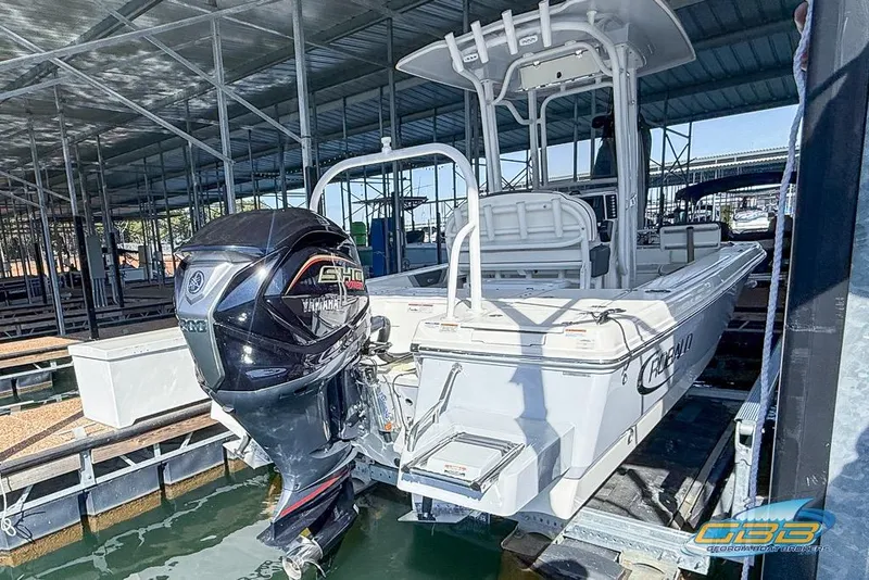 Slide: The Image of 2023 Robalo 226 Cayman boat with Yamaha engine docked in a marina. - 42