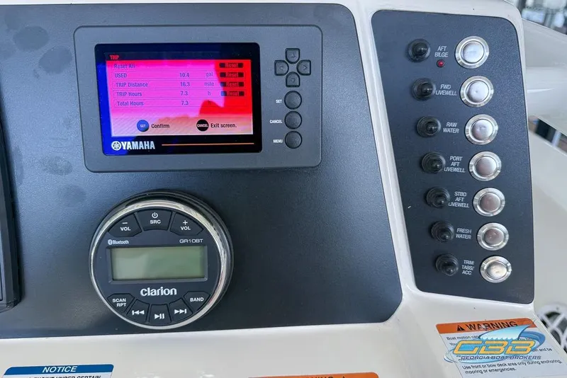 Slide: The Image of Dashboard of 2023 Robalo 226 Cayman with Yamaha display and Clarion audio controls. - 46