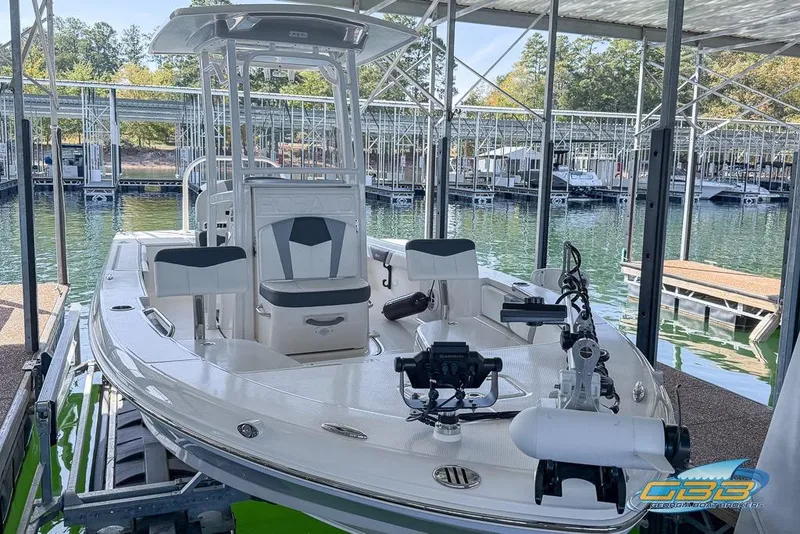 Slide: The Image of 2023 Robalo 226 Cayman boat docked in a marina, showcasing sleek design and modern features. - 47