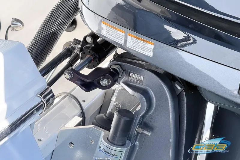 Slide: The Image of Close-up of 2023 Robalo 226 Cayman boat engine components and steering mechanism. - 48