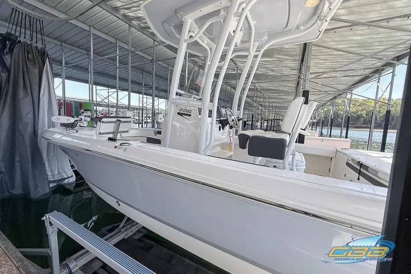 Slide: The Image of 2023 Robalo 226 Cayman boat docked in a covered marina. - 5