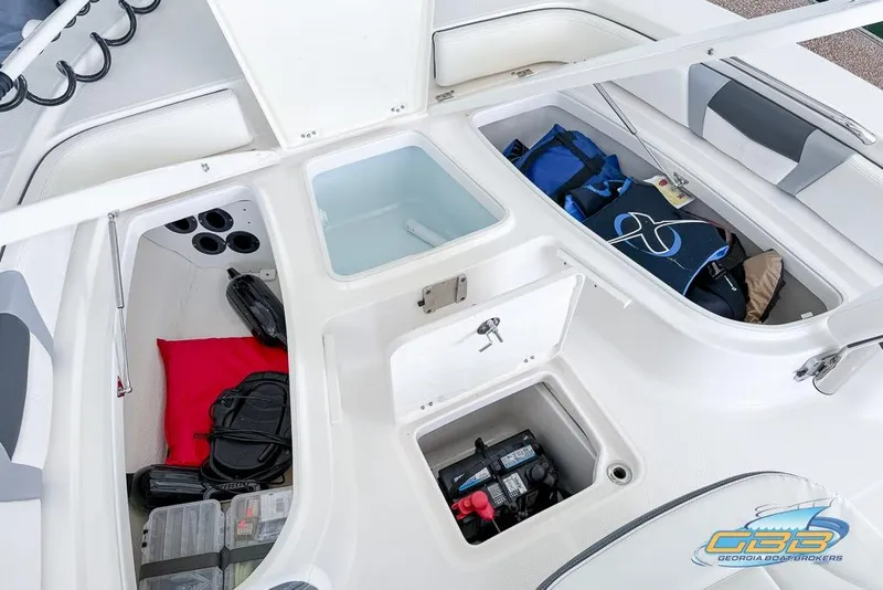 Slide: The Image of 2023 Robalo 226 Cayman boat storage compartments with gear and equipment. - 51