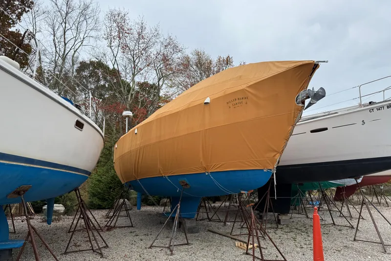 Slide: The Image of 2006 Catalina 36 MkII sailboat covered and stored on stands outdoors. - 11