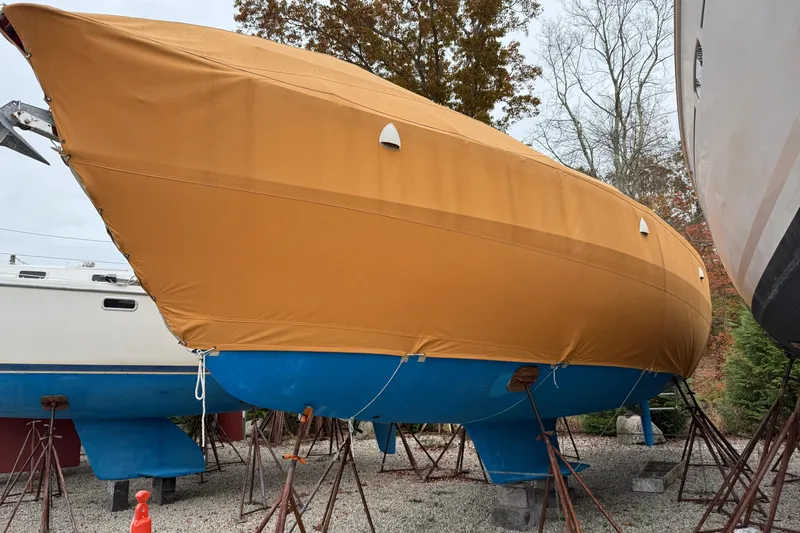 Slide: The Image of Catalina 36 MkII 2006 sailboat with tan cover and blue hull on stands. - 12