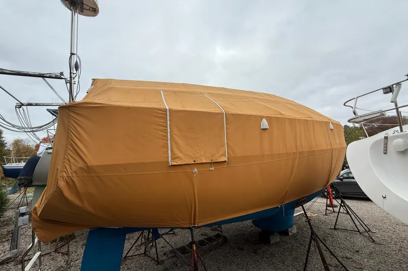 Slide: The Image of Catalina 36 MkII 2006 sailboat covered with a protective tarp on a gravel lot. - 14