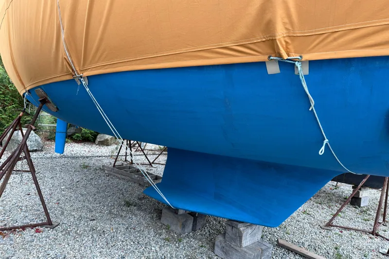 Slide: The Image of Catalina 36 MkII 2006 sailboat with blue hull and tan cover on stands. - 17