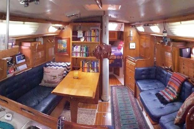 Slide: The Image of Interior of 2006 Catalina 36 MkII sailboat with cozy seating and wooden furnishings. - 36