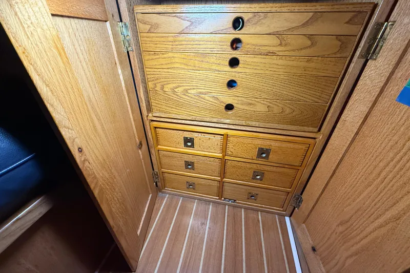 Slide: The Image of Wooden cabinetry inside a 2006 Catalina 36 MkII sailboat, featuring multiple drawers. - 41