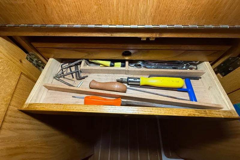 Slide: The Image of Tool drawer in a 2006 Catalina 36 MkII sailboat, featuring various hand tools. - 42