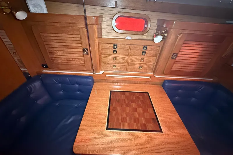 Slide: The Image of Interior of 2006 Catalina 36 MkII sailboat with wooden cabinetry and blue seating. - 44