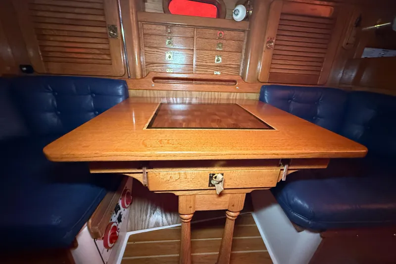 Slide: The Image of Interior of 2006 Catalina 36 MkII sailboat with wooden table and blue seating. - 45