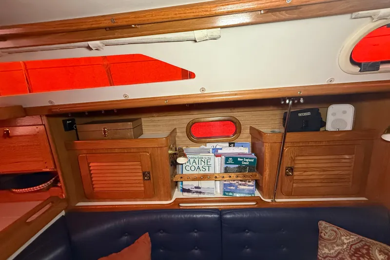 Slide: The Image of Interior of 2006 Catalina 36 MkII sailboat with wooden cabinets and nautical books. - 46