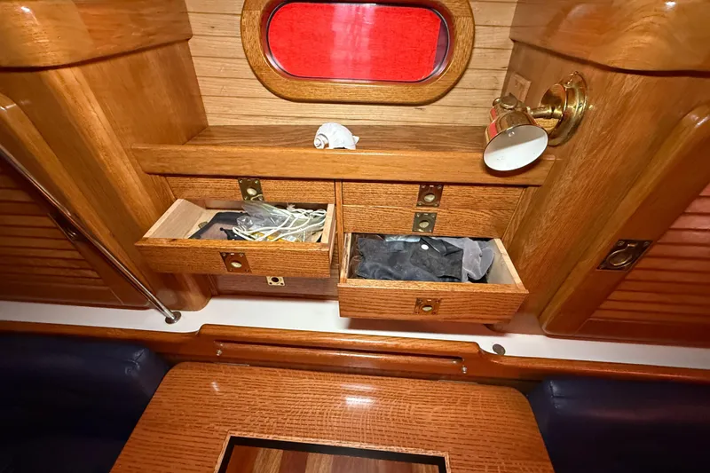 Slide: The Image of Wooden interior of 2006 Catalina 36 MkII sailboat with open drawers and red porthole. - 47