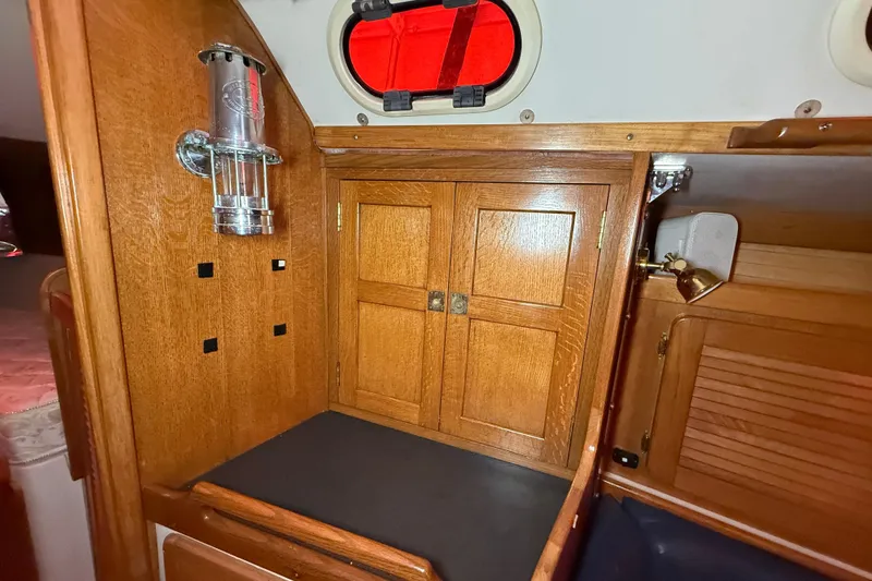 Slide: The Image of Interior of 2006 Catalina 36 MkII sailboat with wooden cabinetry and porthole. - 49