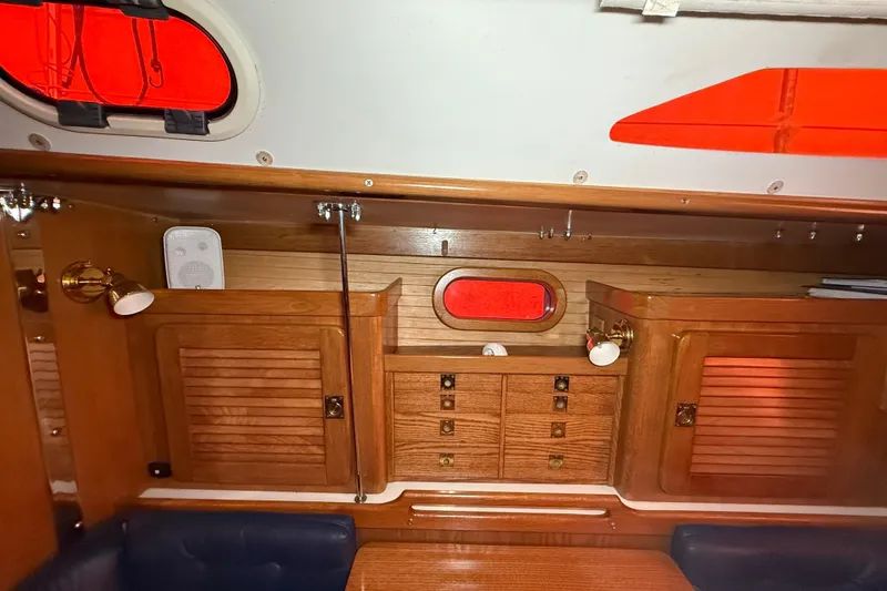 Slide: The Image of Interior of 2006 Catalina 36 MkII sailboat with wooden cabinets and red-tinted windows. - 50