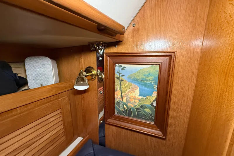 Slide: The Image of Interior of 2006 Catalina 36 MkII with wood paneling and framed artwork. - 51
