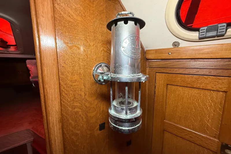 Slide: The Image of Vintage yacht lantern on wooden interior of 2006 Catalina 36 MkII sailboat. - 52