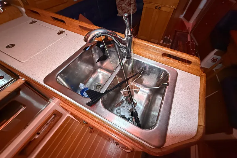 Slide: The Image of Galley sink in 2006 Catalina 36 MkII sailboat with faucet and utensils. - 55