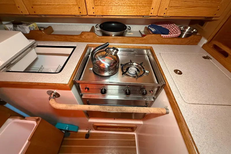 Slide: The Image of Compact galley kitchen in 2006 Catalina 36 MkII sailboat with stove and kettle. - 56