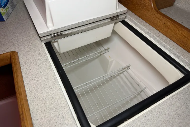 Slide: The Image of Open refrigerator compartment in 2006 Catalina 36 MkII sailboat galley. - 59