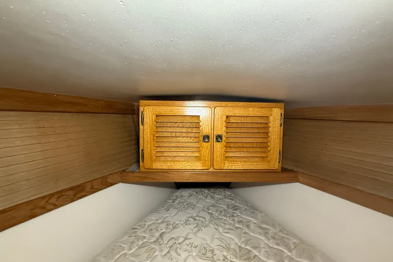 Slide: The Image of Wooden cabinet in 2006 Catalina 36 MkII sailboat interior, above a patterned mattress. - 67