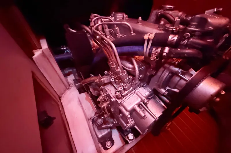 Slide: The Image of Engine of a 2006 Catalina 36 MkII sailboat, detailed view in red lighting. - 78