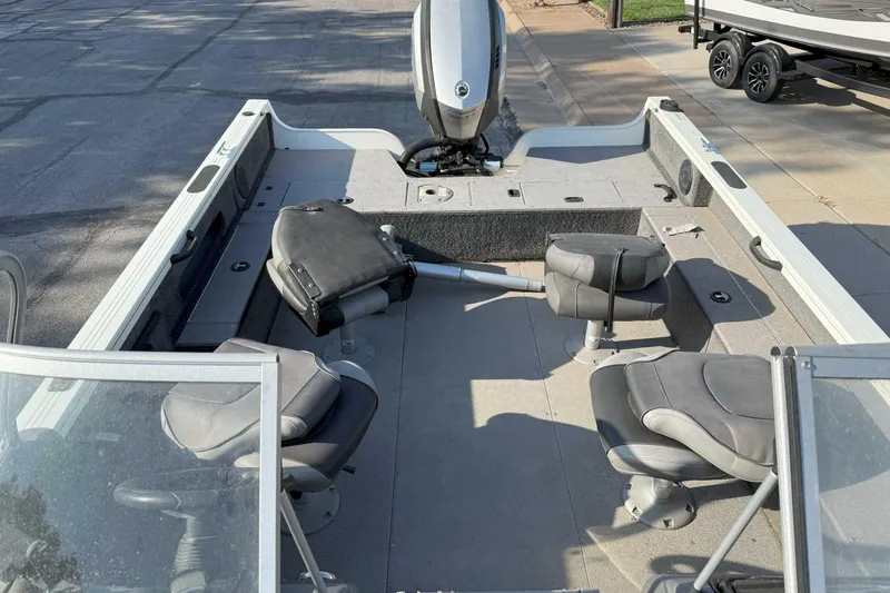 Slide: The Image of 2017 Crestliner 1950 Fish Hawk boat interior with seating and motor. - 4