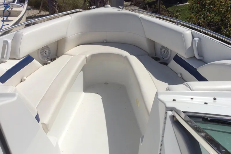 Slide: The Image of 2005 Formula 260 Bowrider boat interior with white seating and blue accents. - 12