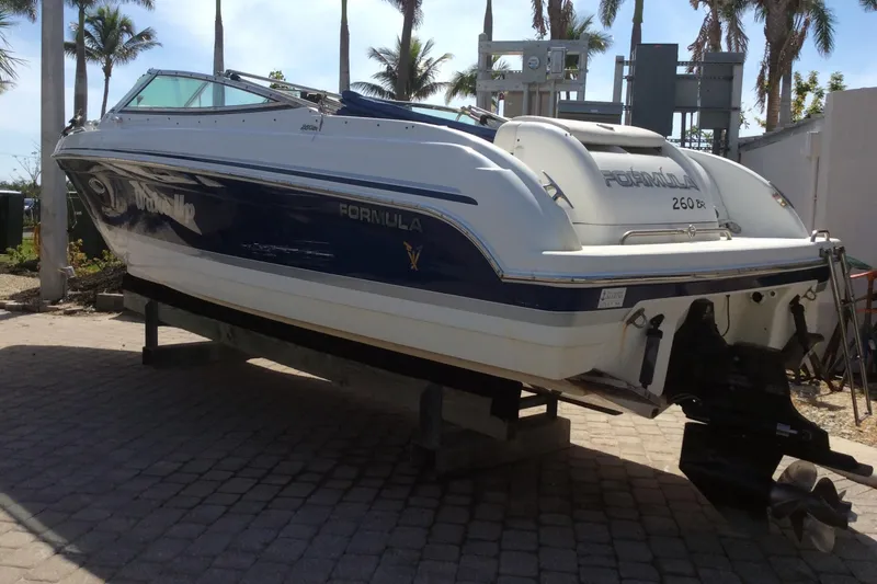 Slide: The Image of 2005 Formula 260 Bowrider boat on a stand, palm trees in background. - 15