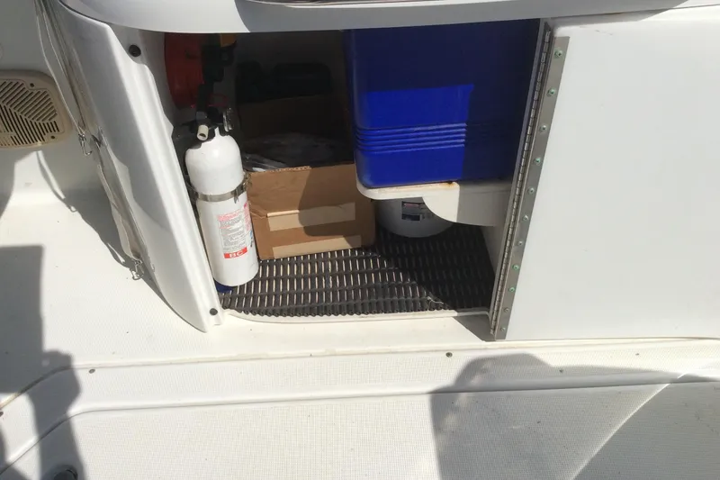 Slide: The Image of Storage compartment on a 2005 Formula 260 Bowrider with cooler and fire extinguisher. - 6