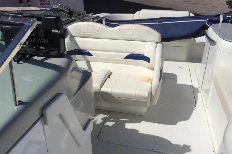 Slide: The Image of 2005 Formula 260 Bowrider interior with white seating and navigation equipment. - 8