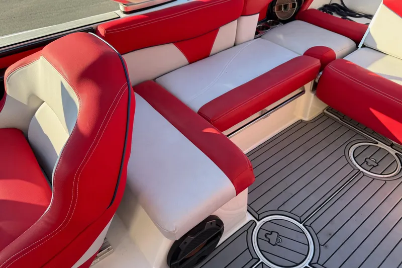 Slide: The Image of 2018 MasterCraft X46 interior with red and white seating and gray flooring. - 10
