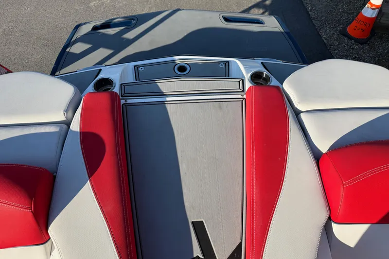 Slide: The Image of 2018 MasterCraft X46 boat interior with red and white seating, cup holders, and deck. - 4