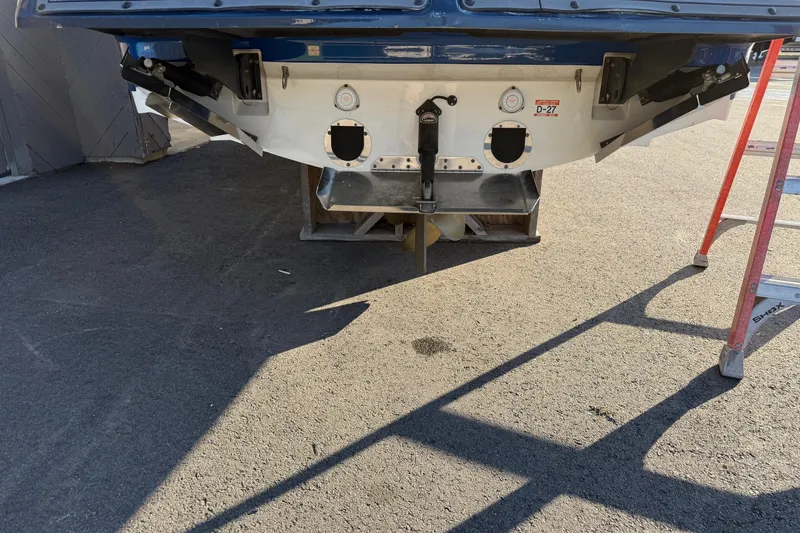 Slide: The Image of Rear view of a 2018 MasterCraft X46 boat on a trailer, with a ladder nearby. - 5