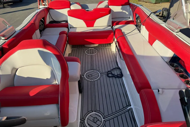 Slide: The Image of 2018 MasterCraft X46 boat interior with red and white seating, gray flooring. - 7