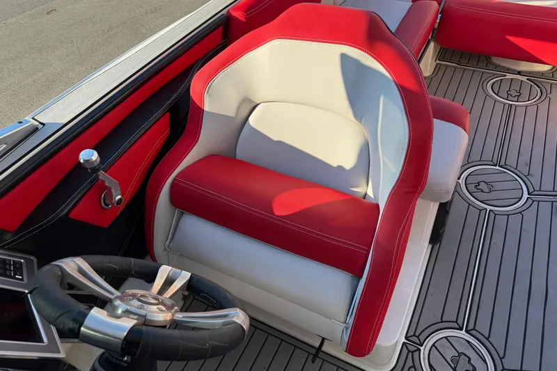 Slide: The Image of 2018 MasterCraft X46 boat interior with red and white seating and steering wheel. - 8